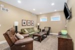 The spacious lower level Great Room has a Queen sofa sleeper, TV, and dining or game table.